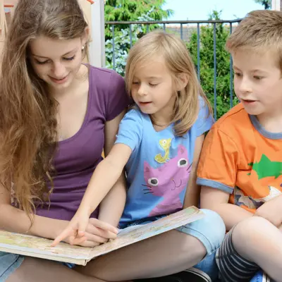 Young girl babysitting two children