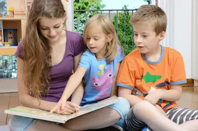 Young girl babysitting two children