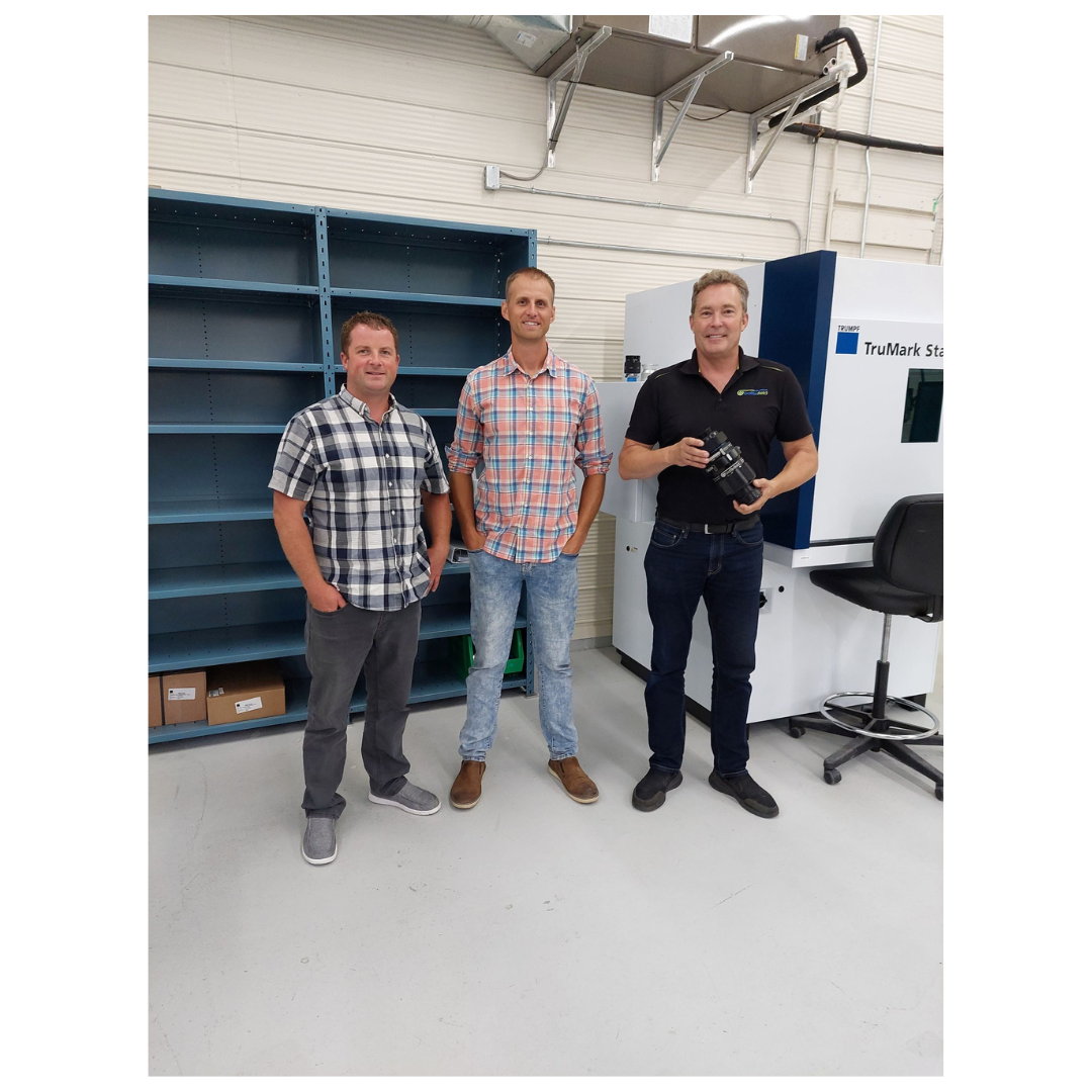 3 Men in front of machines