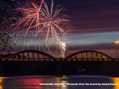 2023 Honourable Mention Photo - Night shot of fireworks bursting over the Caledonia bridge and Grand River, taken by Anand Kasote