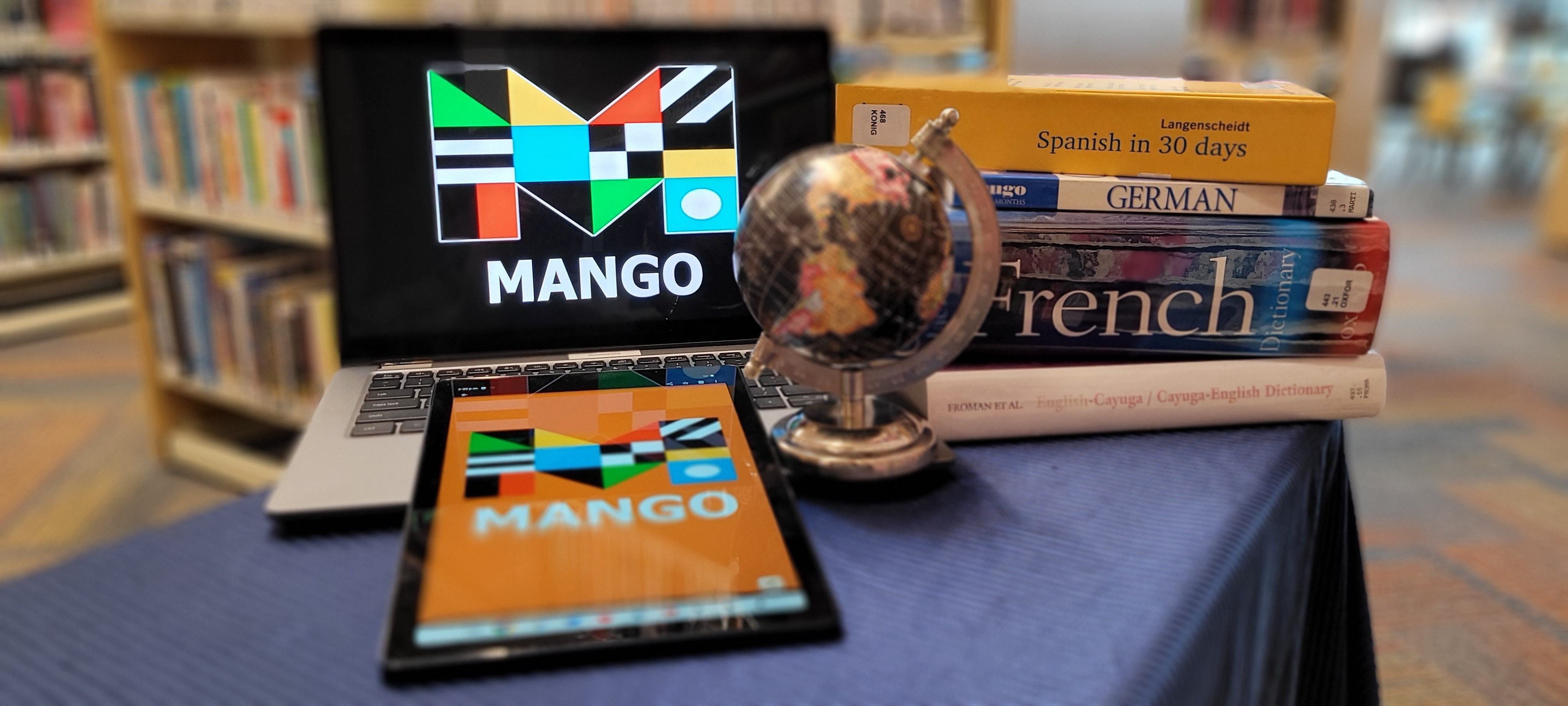 laptop and tablet with globe and language learning books