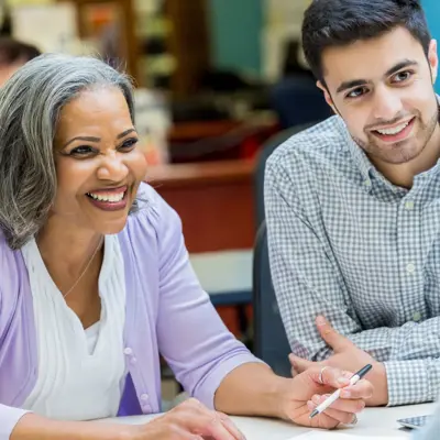 Older Women And Young Man At A Table