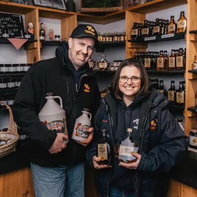 People holding maple syrup