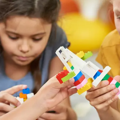 Three children playing with LEGO