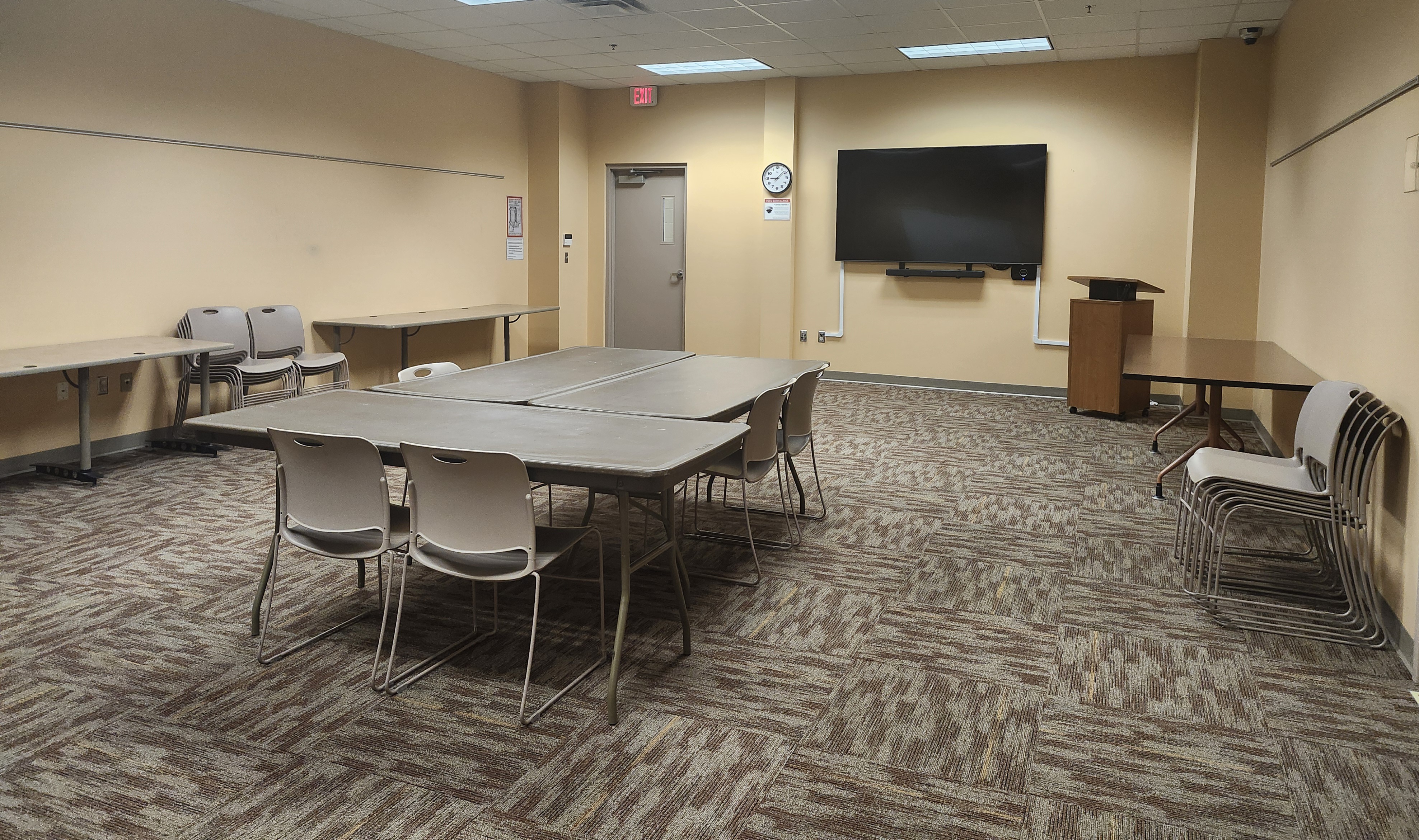 Caledonia library meeting room with boardroom style table and smart screen