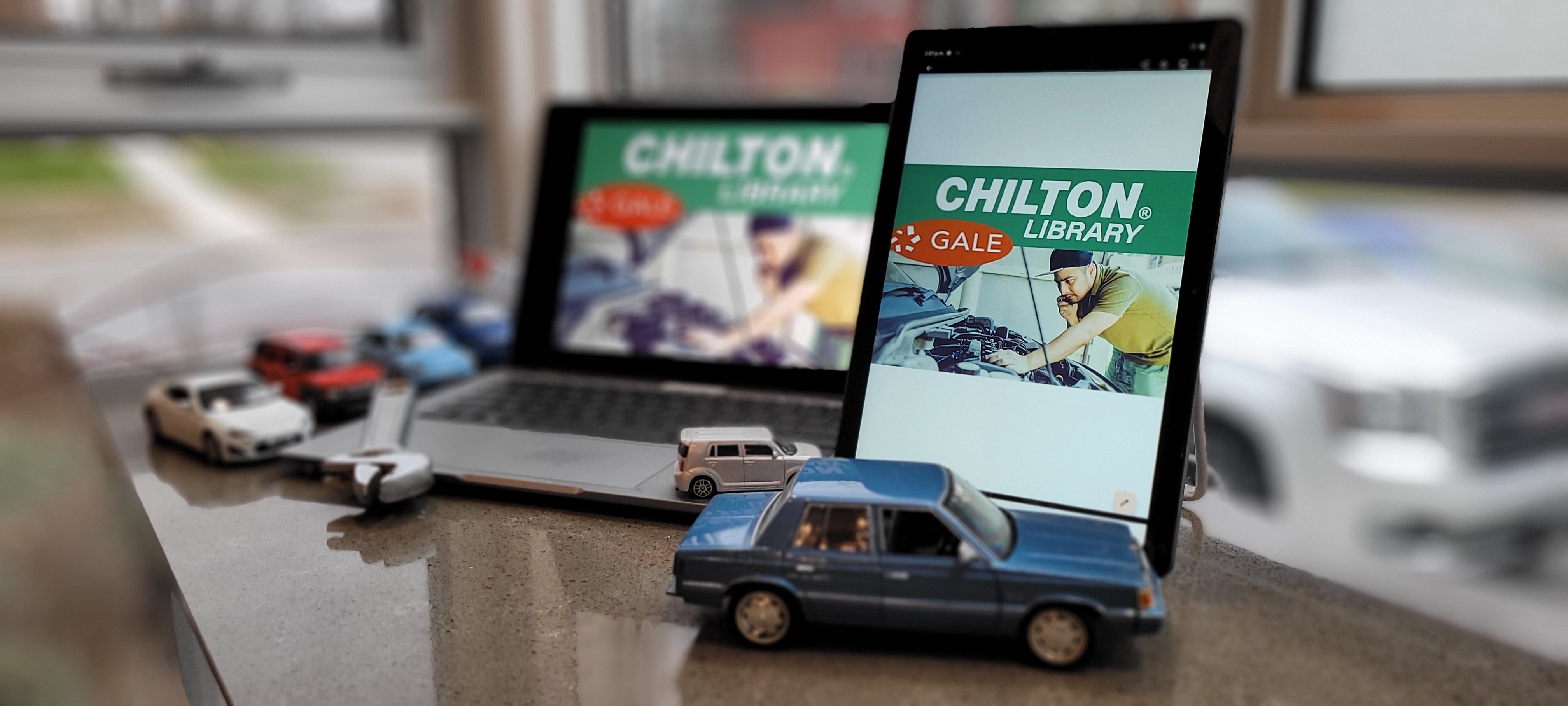 laptop and tablet with die-cast cars 