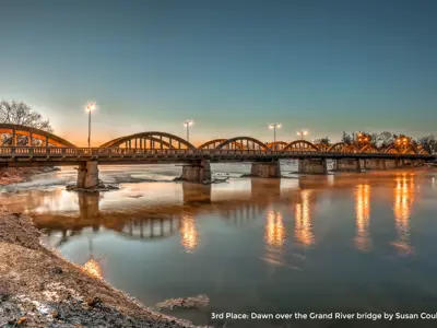 2020 3rd Place Photo - Soft dawn light glowing over the Argyle Street bridge and Grand River, taken by Susan Coulthart