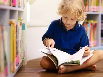 Little boy reading a book