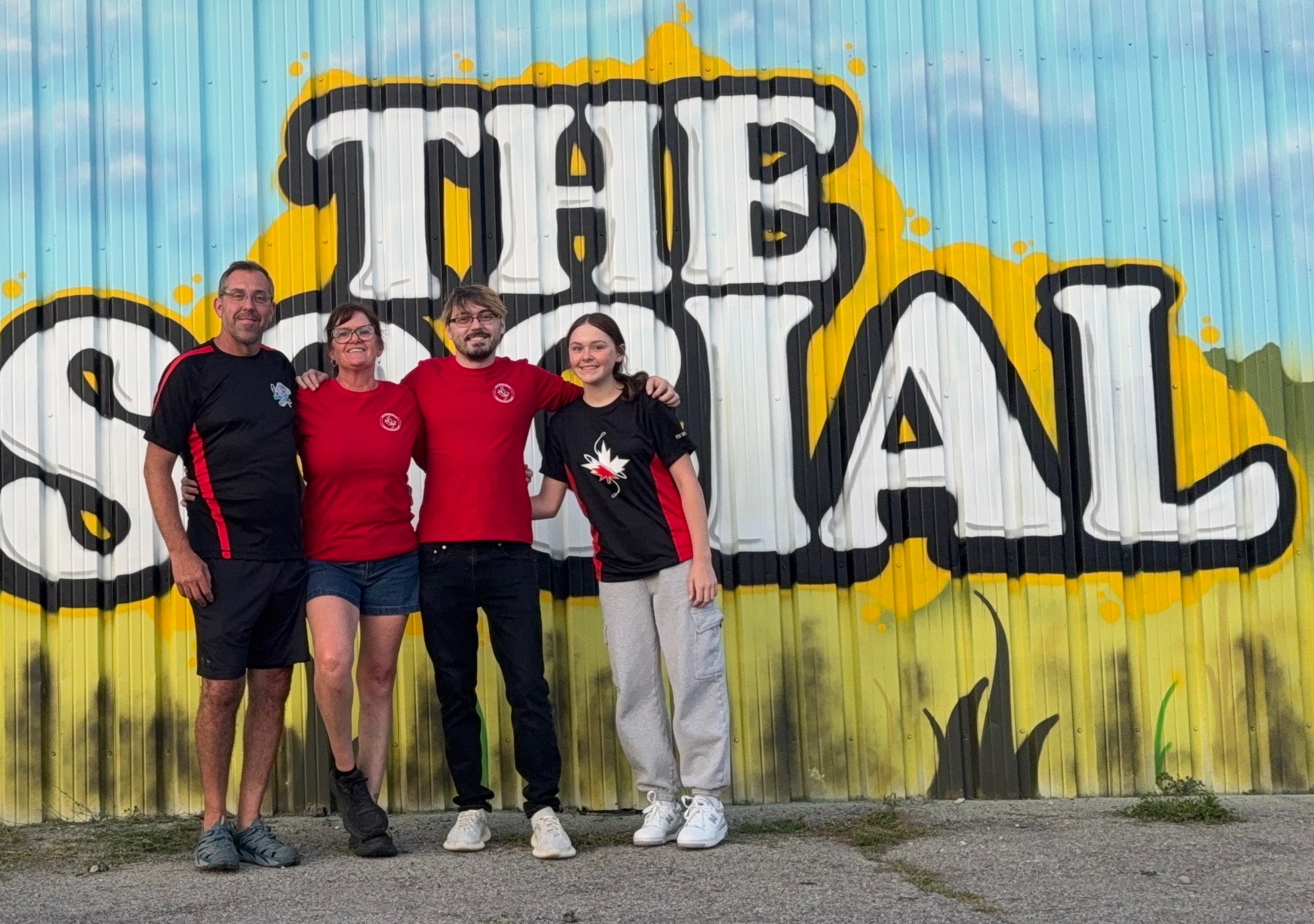 4 people standing in front of a building